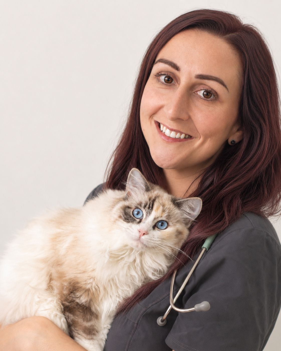 Black and white portrait of Dr Katie Ford, Millennial veterinary surgeon, holding a cat